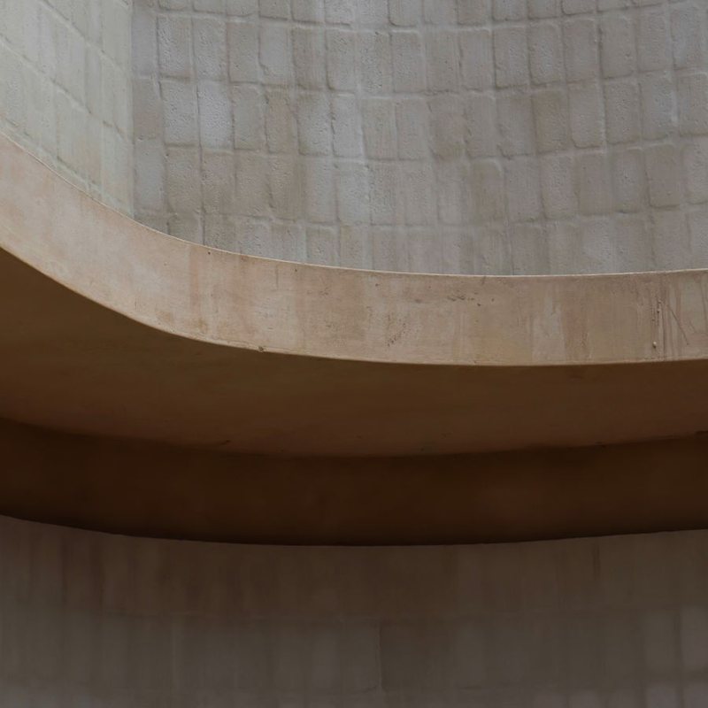 Curved travertine wall in warm light